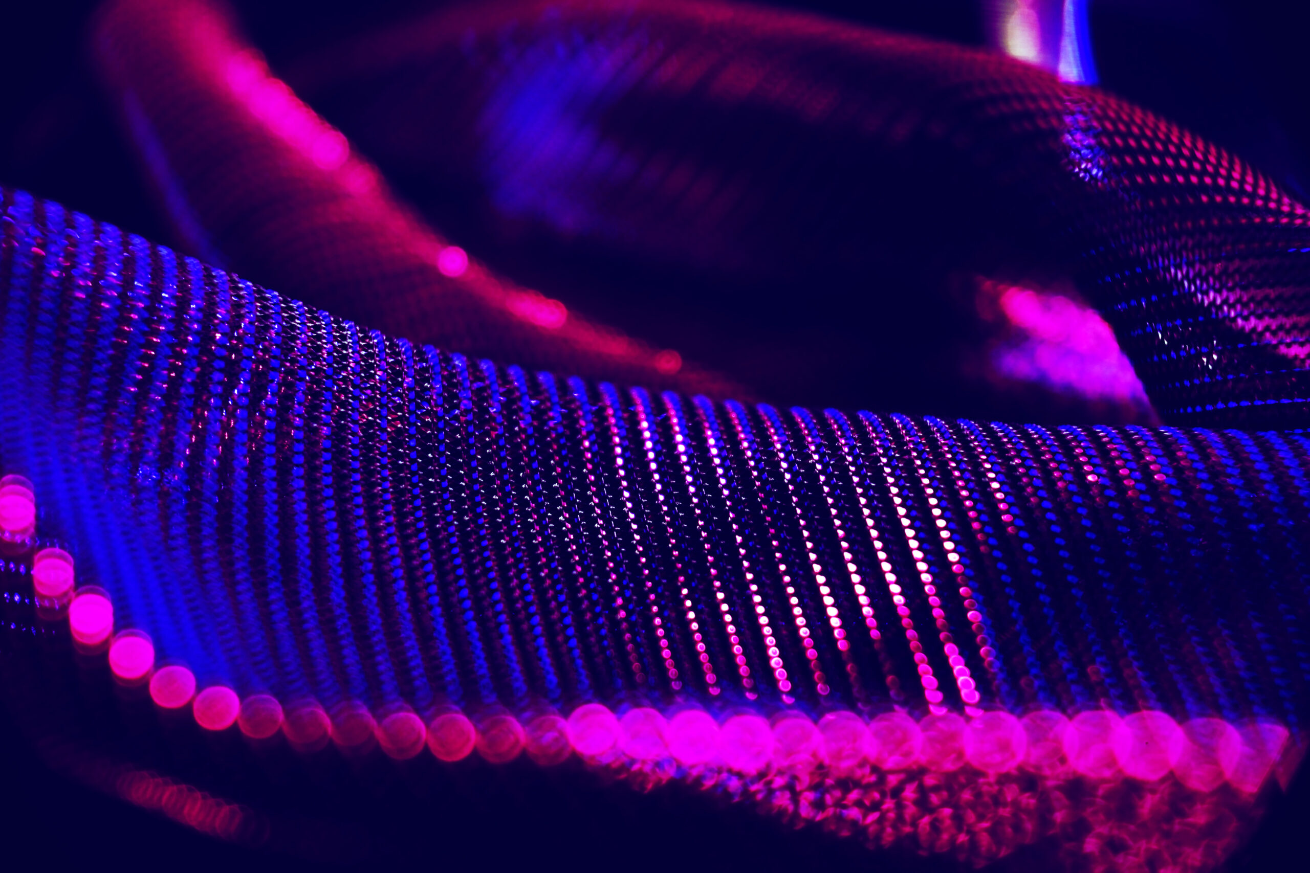 An amazing and beautiful macro of black clothes with pink and bl